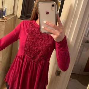 red long sleeve top with embroidered detail